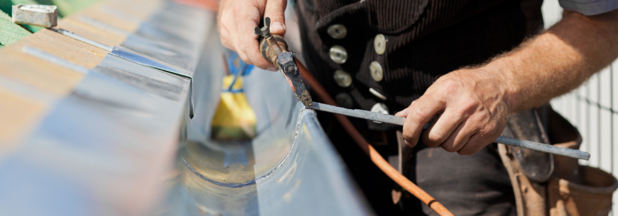Close-up,Of,A,Roofer,Applying,Weld,Into,The,Gutter,Parts